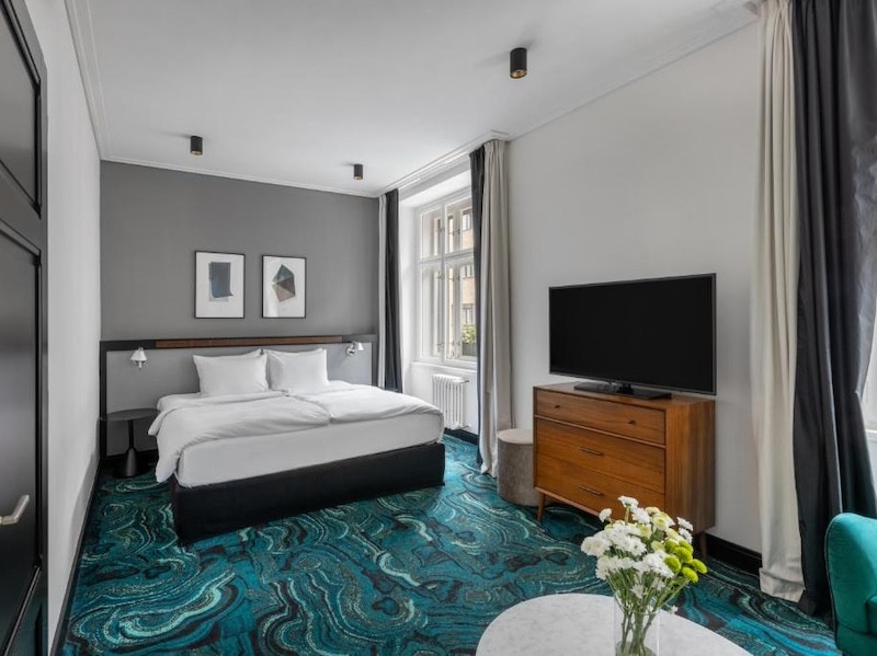 Habitación amplia y moderna del hotel Numa I Praga Republika con camas cómodas.